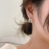 ZircoGlimmer | Straal verfijning uit met deze oogverblindende oorbellen!